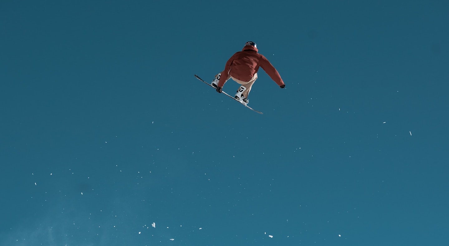 A snowboarder catching some air