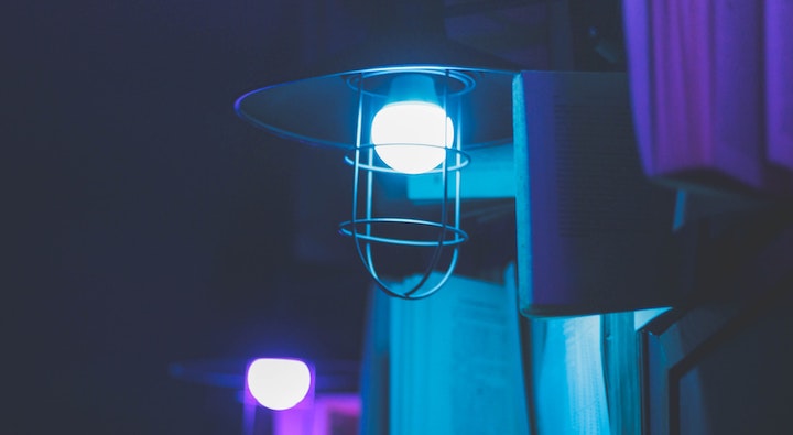 An industrial light fixture in blue and purple