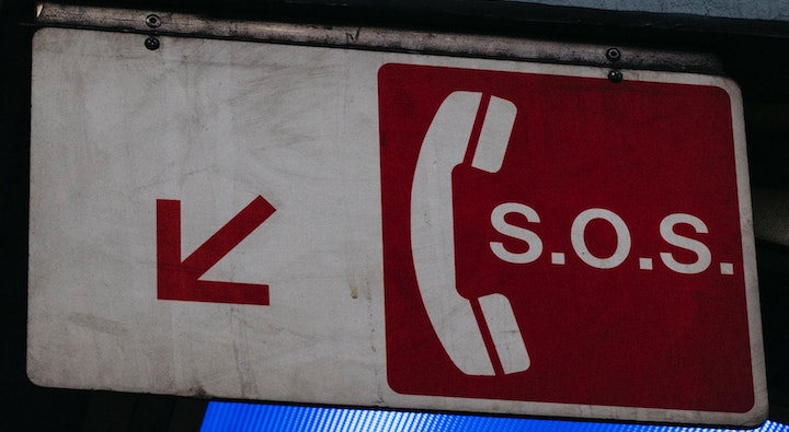 A white and red SOS phone sign