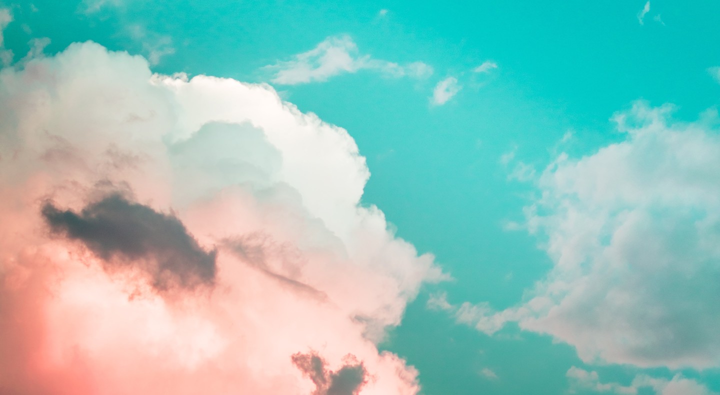Pink and white clouds against a blue sky