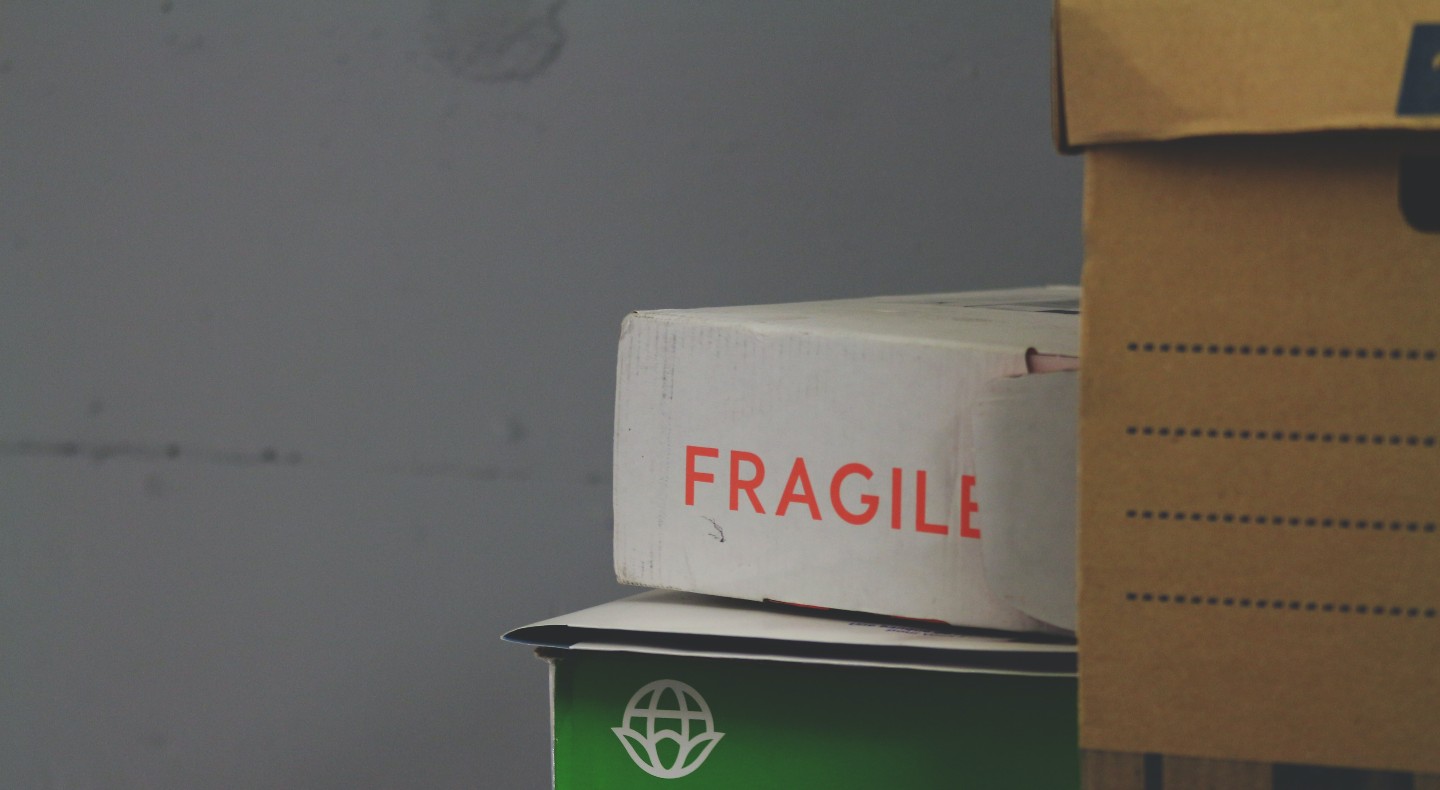 A pile of cardboard boxes. One has fragile written on it.